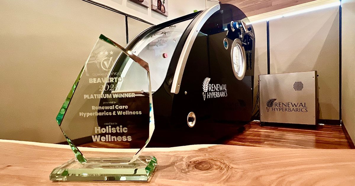 Best of Beaverton Platinum Award in front of Pursuit 2.0 ATA hyperbaric chamber at Renewal Care Hyperbarics & Wellness in Beaverton, Oregon